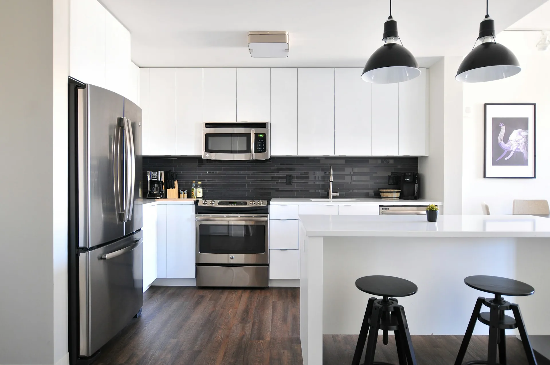White kitchen with island and pendants
